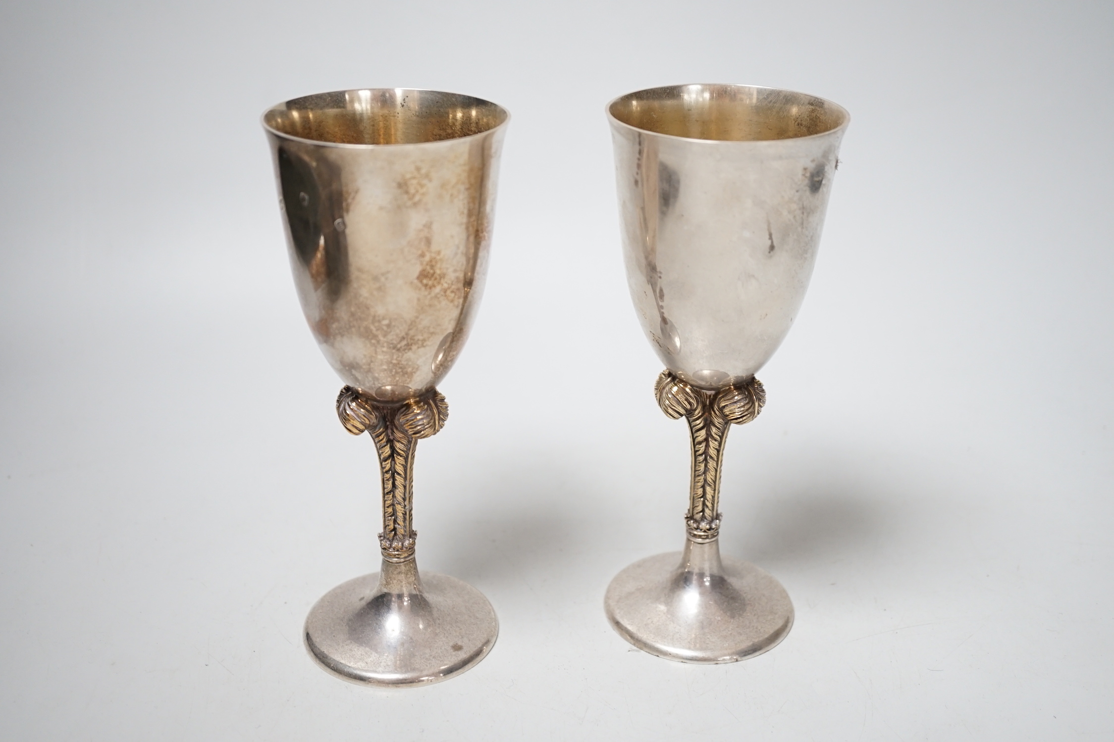 A pair of Elizabeth II silver goblets, with Prince of Wales feathers stem, St. James House Co. London, 1981, height 17.1cm, 12.8oz.